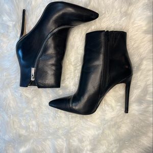 Aldo high-heeled boots with aesthetic zipper across the top.